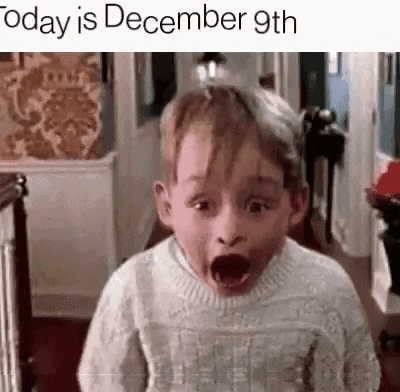a little boy in a sweater is making a funny face .