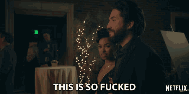 a man and a woman are standing next to each other with the caption " this is so fucked " above them