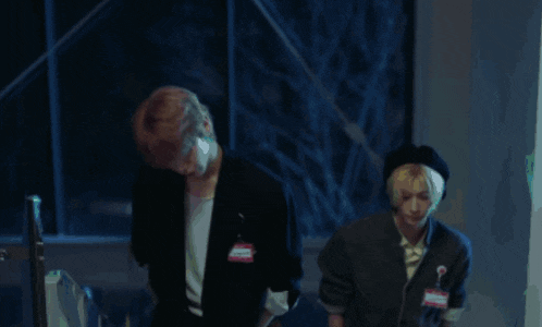 two men are standing next to each other in a dark room and one of them has a name tag that says ' amanda '