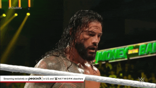 a man in a wrestling ring with a peacock logo