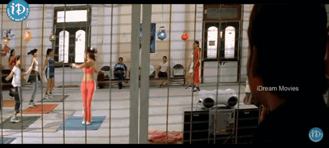 a group of people are in a room with a sign that says i dream movies