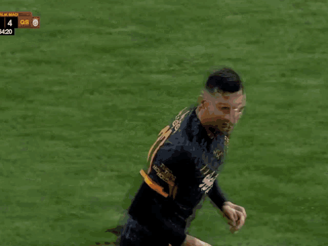 a soccer player wearing a black and orange jersey that says wow shopping on it