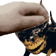 a close up of a hand petting a bee with horns