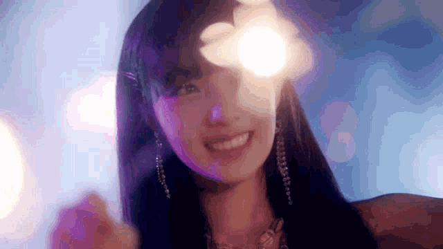 a close up of a woman 's face with a light shining through her eyes .