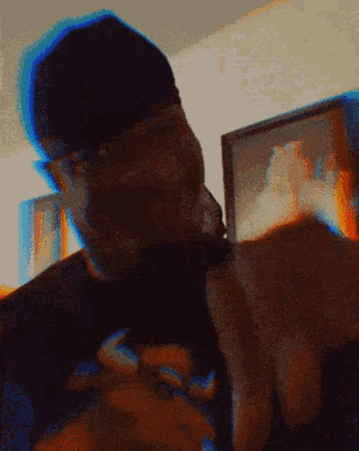 a blurry picture of a man wearing a hat and a shirt that says ' a ' on it