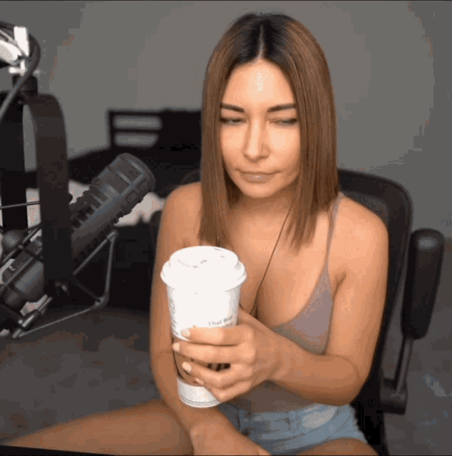 a woman holding a cup of coffee that says that brew
