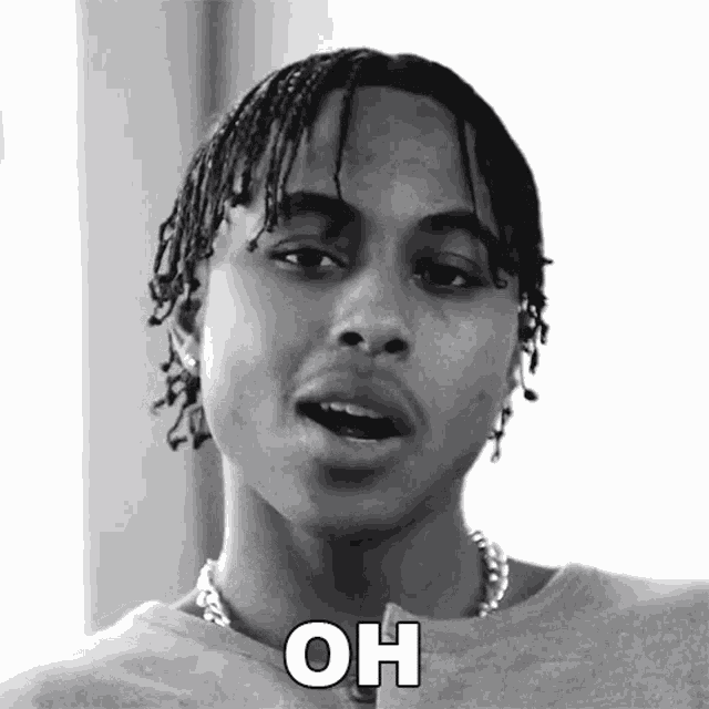 a black and white photo of a young man with dreadlocks and the words `` oh '' written on his face .