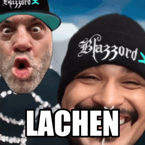 two men are posing for a picture and one has a hat that says blazzard on it