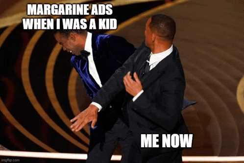 two men in suits are fighting with a caption that says margarine ads when i was a kid me now