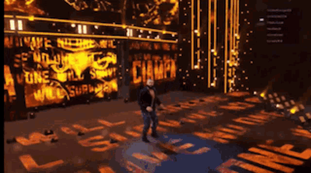 a man stands on a stage in front of a large screen that says champ