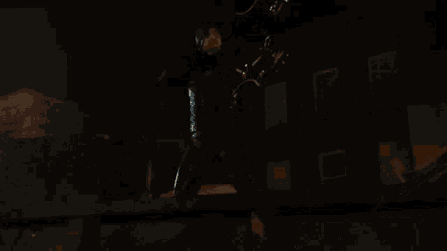 two men are standing next to each other in a dark room with fire coming out of their hands .