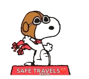 snoopy wearing a hat and scarf is sitting on a red cushion .