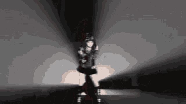 a woman with red hair is standing in a dark room with the number 50 on her hat