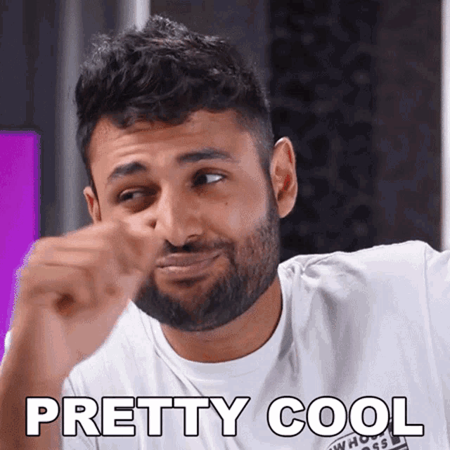 a man with a beard is wearing a white shirt that says " pretty cool "