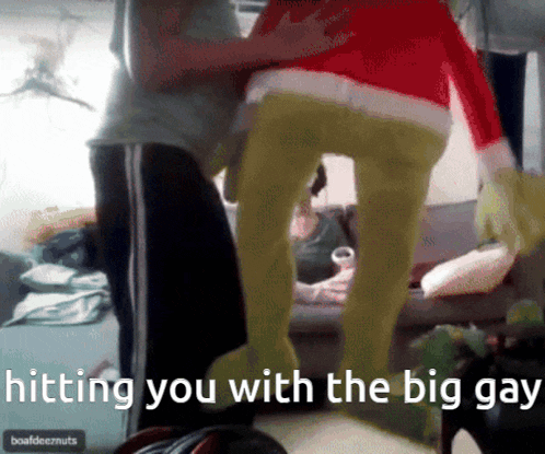 a person in a grinch costume is standing next to another person
