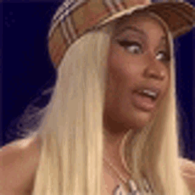 a woman with long blonde hair wearing a hat and a necklace .