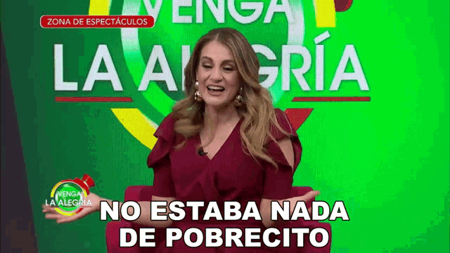 a woman in a red dress is smiling in front of a green background that says la alegria no estaba nada de pobrecito