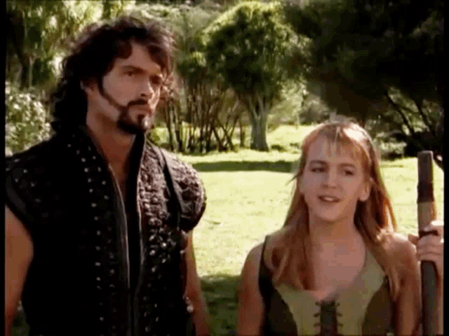 a man with a beard and a woman standing next to each other