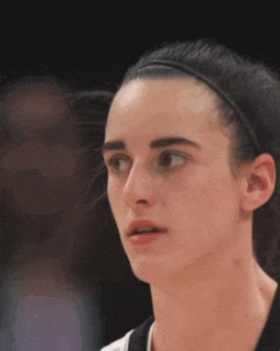 a close up of a woman 's face with a headband