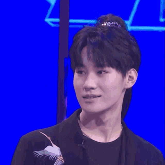 a man with a smiley face on his head and chinese writing on the bottom