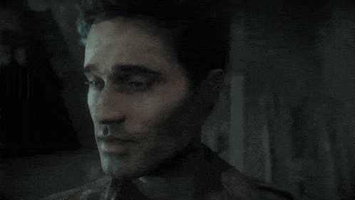 a close up of a man 's face in a video game with the number 13 on his neck