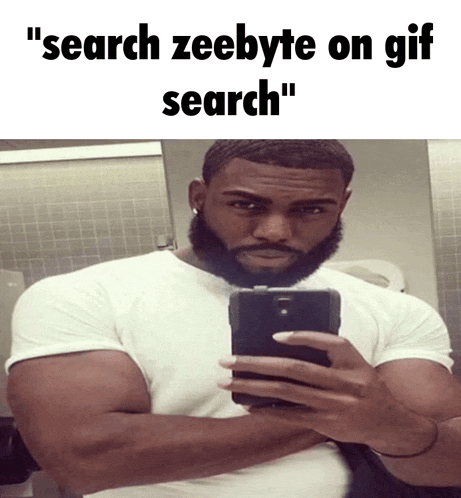 a man with a beard is taking a selfie in a bathroom
