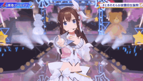 a girl in a white dress with a microphone is on a stage