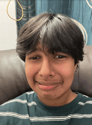 a young boy making a funny face with his mouth open