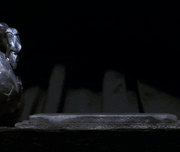 a person 's hand is glowing in the dark with a blue light coming out of it .