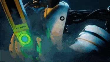 a close up of a robot 's head with a green light on it .