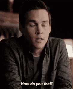 a young man is sitting at a table with his eyes closed and asking how do you feel .