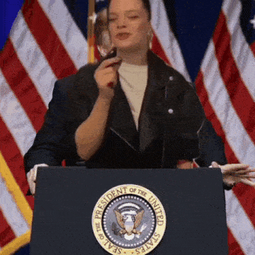 a woman stands at a podium with the seal of the president of the united states on it