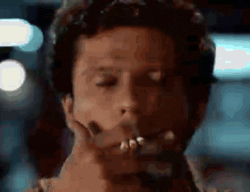 a close up of a man 's face with his hand on his face