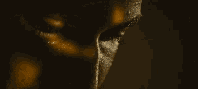 a close up of a person 's face with sweat on it