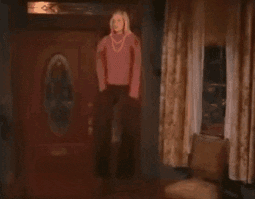 a person is standing in a room with a red light coming out of them .