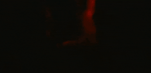 a man and woman are having sex in a dark room .