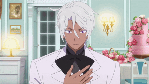 a man with white hair and a black bow tie is standing in front of a pink cake