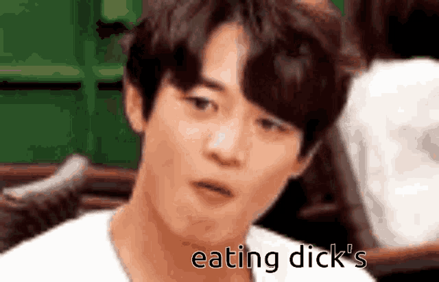 a close up of a man 's face with the words `` eating dick 's '' written below him .