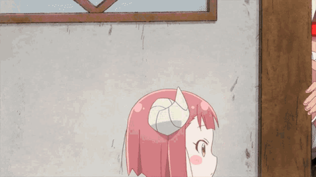 a girl with pink hair and horns is standing in front of a door