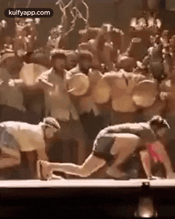 a group of people are dancing on a stage in front of a drum set .