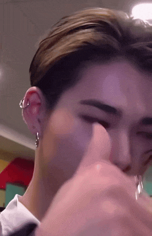 a close up of a person 's ear with a piercing