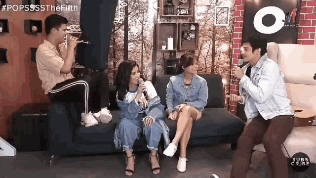 a group of people sitting on a couch with a man playing a trumpet