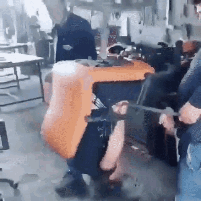 a group of people are working on a machine in a room .