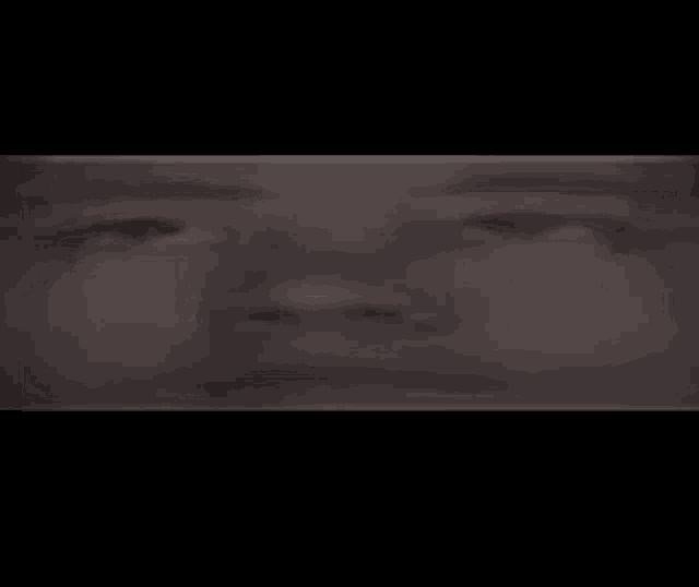 a close up of a person 's face with a black background .