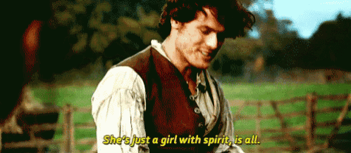 a man is standing in a field with the words she 's just a girl with spirit is all