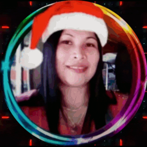 a woman is wearing a santa hat in a rainbow colored circle