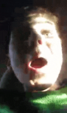 a close up of a person 's face with their mouth open and the sun shining on it .