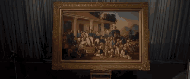 a large framed painting of a group of people in front of a house