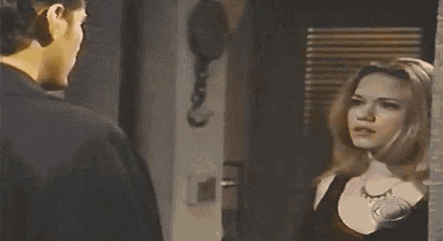 a man and a woman are looking at each other in a blurry photo
