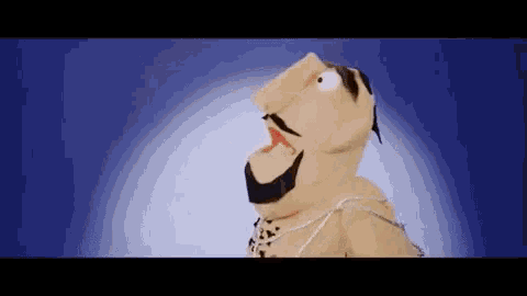 a puppet with a beard and mustache is standing in front of a blue light .
